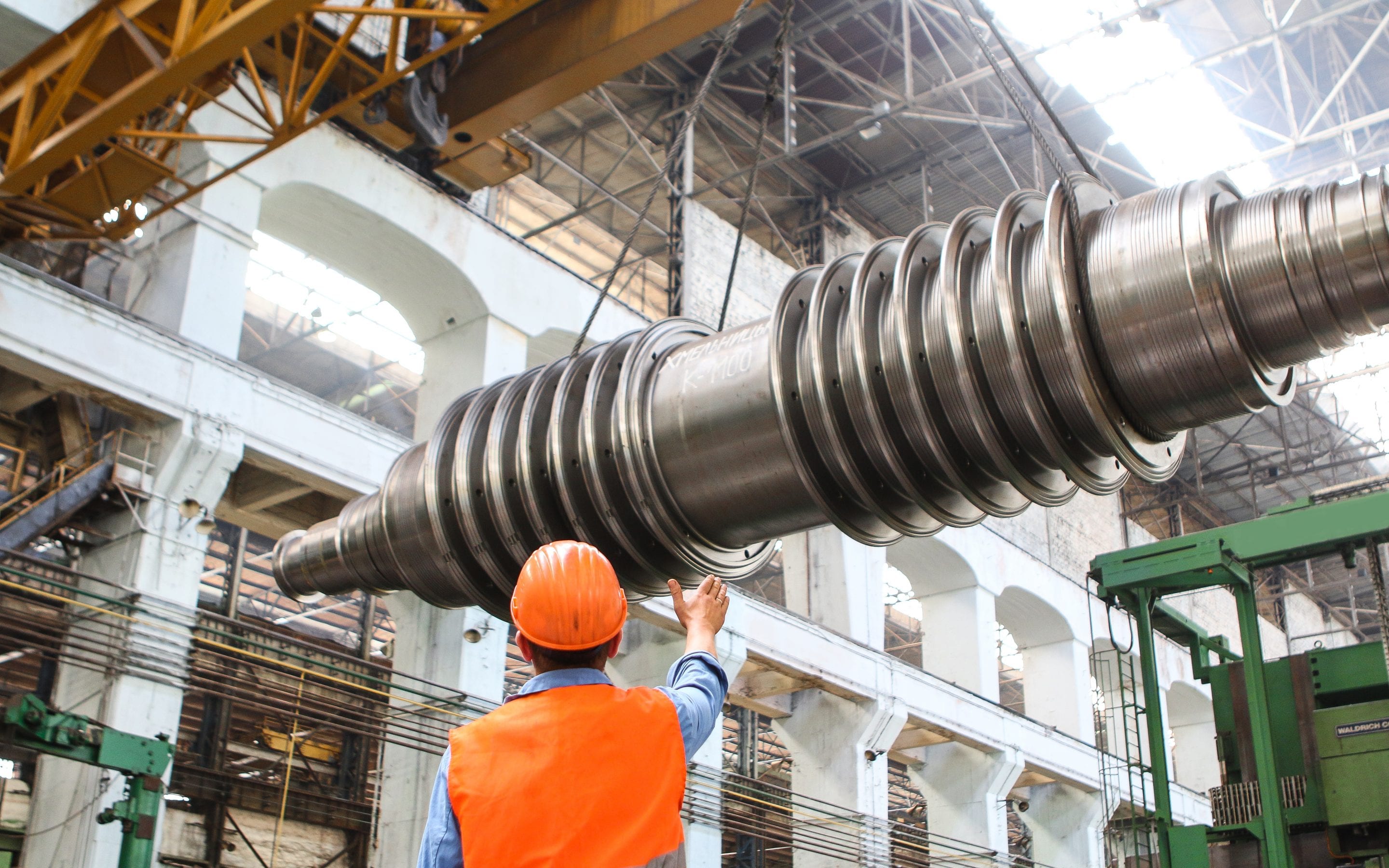 man-standing-beside-heavy-equipment-2760242 On the Line: Exposing Theft in Manufacturing